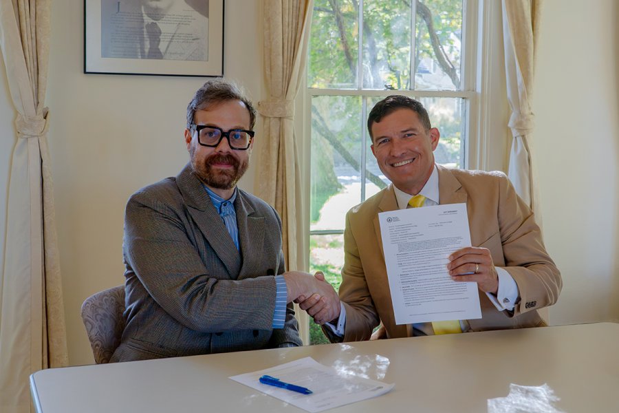 WMU-AAUP President Dr. Andrew Hennlich (left) and WMU President Russ Kavalhuna renewed the partnership between the faculty union and the University.