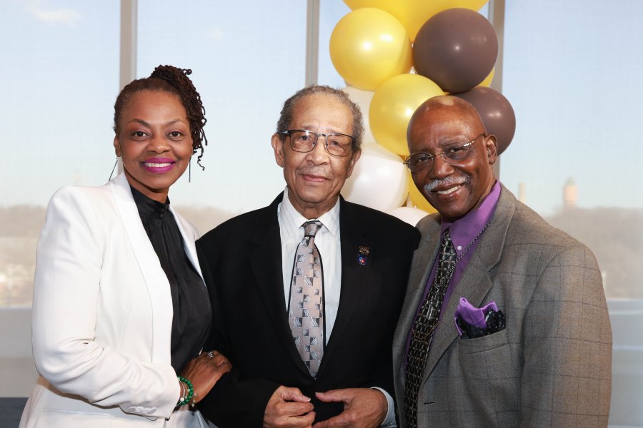 Lewis Walker stands with two other people at a gala.