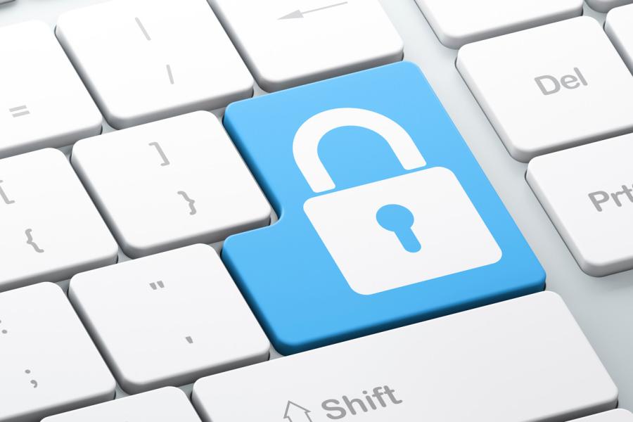 Close up photo of a computer keyboard with a key with a lock symbol on it.