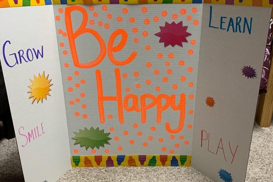 "Be Happy" is written on a privacy screen.