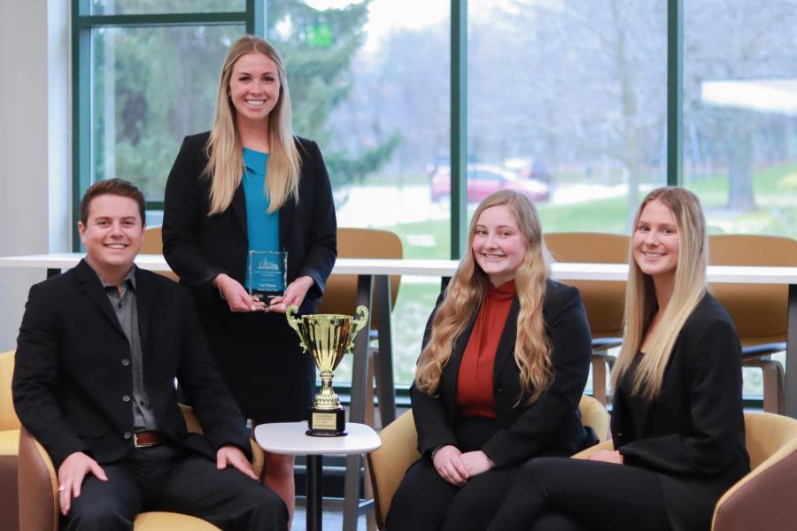 Four student, pose with the Desert Cup trophy.