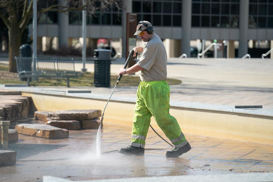 Cleaning the fountain on main campus.