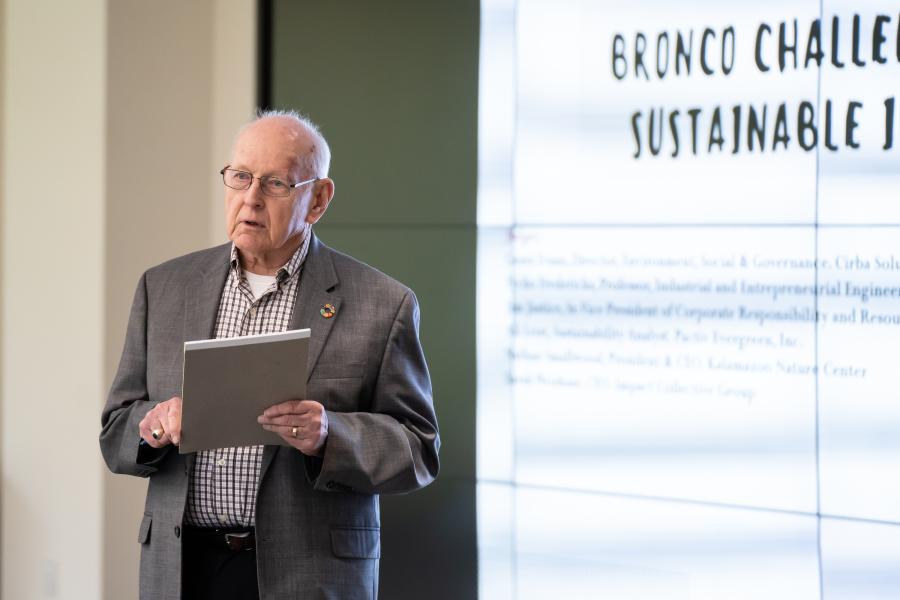 Dr. Neil Drobny stands at the front of a classroom.