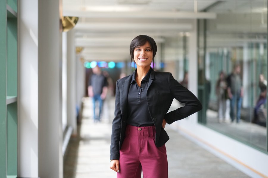 A student in business attire standing authoritatively in the Haworth College of Business.
