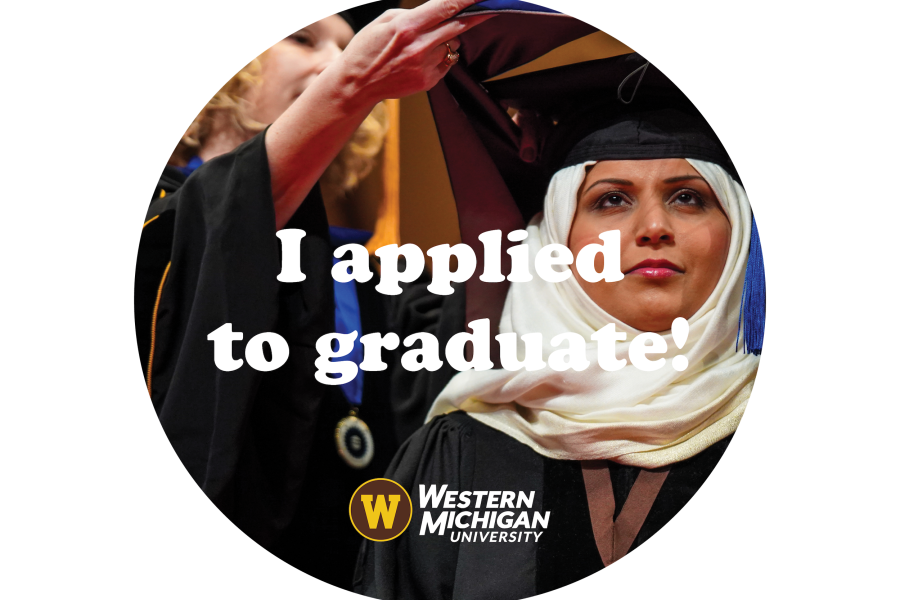 A doctoral graduate being hooded onstage during a commencement ceremony