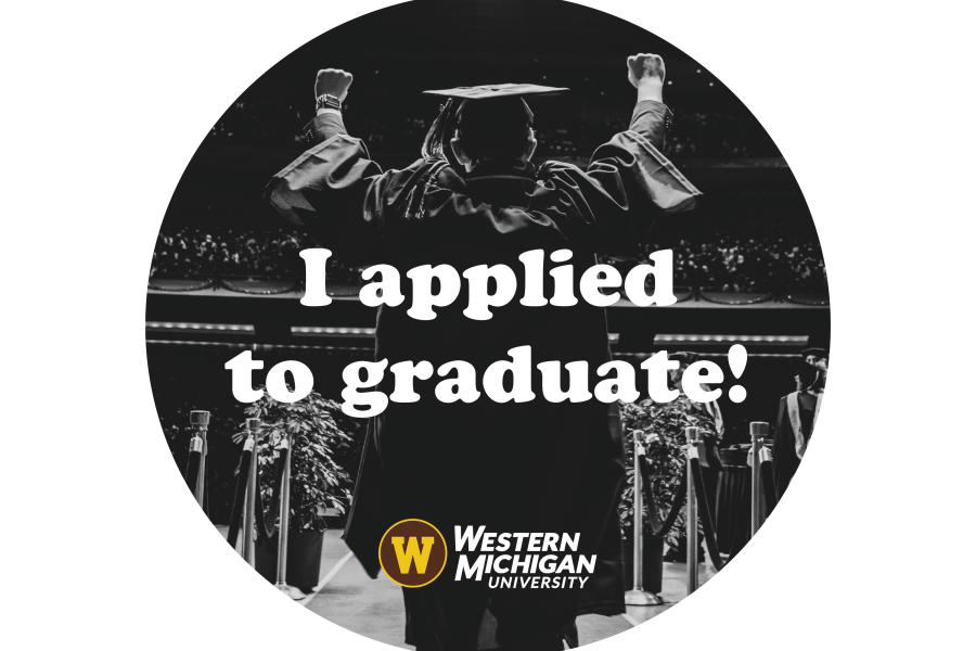 A graduate walking onstage at a commencement ceremony