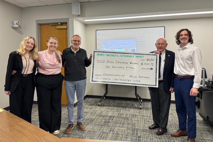 Full Disclosure team members stand with business faculty after winning first place in the Bronco Challenge for Sustainable Impact.