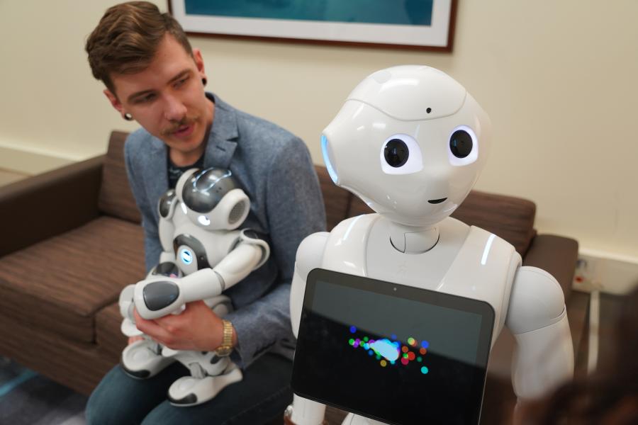 Student with humanoid robots, Pepper and NAO