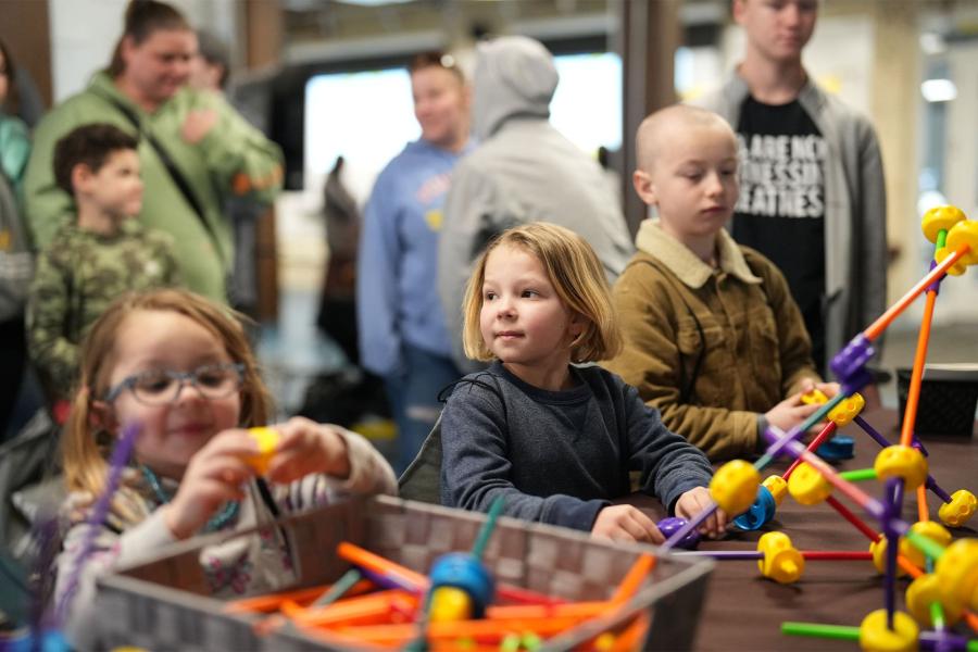 Kids deep in thought at the Knex assembly station.