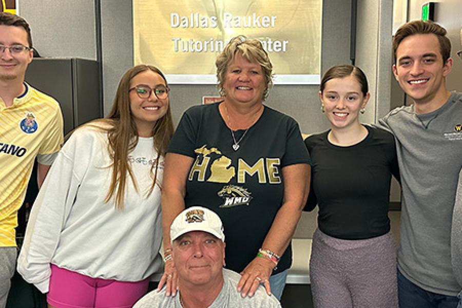 Fred and Renae Rauker pictured outside the Dallas Rauker Tutoring Center with tutors and Dr. Bret Wagner