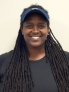Kathleen Hawkins, Junior Tennis Director, standing in front of a blank background.