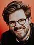 Headshot photo of man, wearing glasses. 