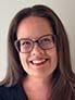 Headshot photo of woman, wearing glasses. 