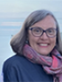 Headshot photo of woman, wearing glasses. 