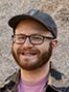 Headshot photo of man, wearing glasses. 