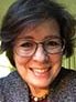 Headshot photo of woman, wearing glasses. 