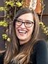 Headshot photo of woman, wearing glasses. 