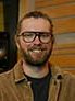 Headshot photo of man, wearing glasses. 