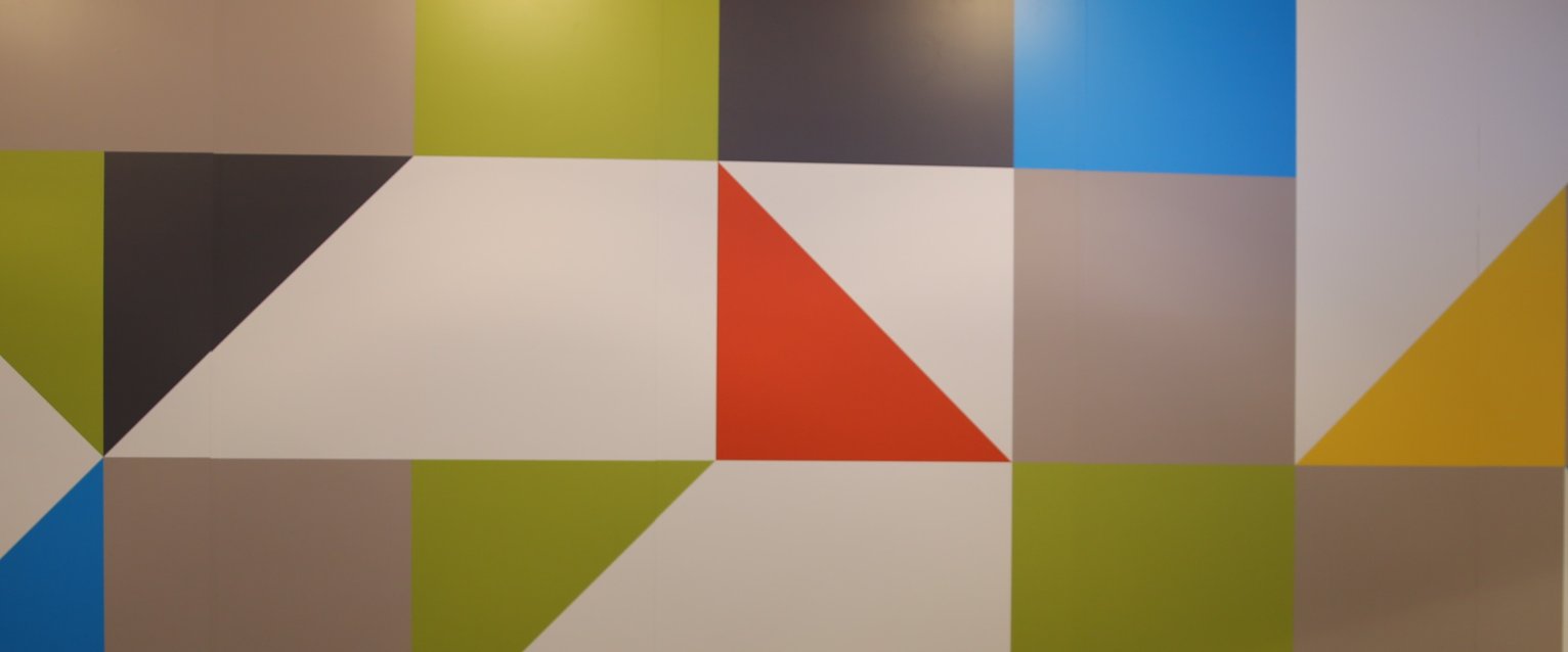 brightly colored geometric shapes on the wall of DASH Grabn Go 