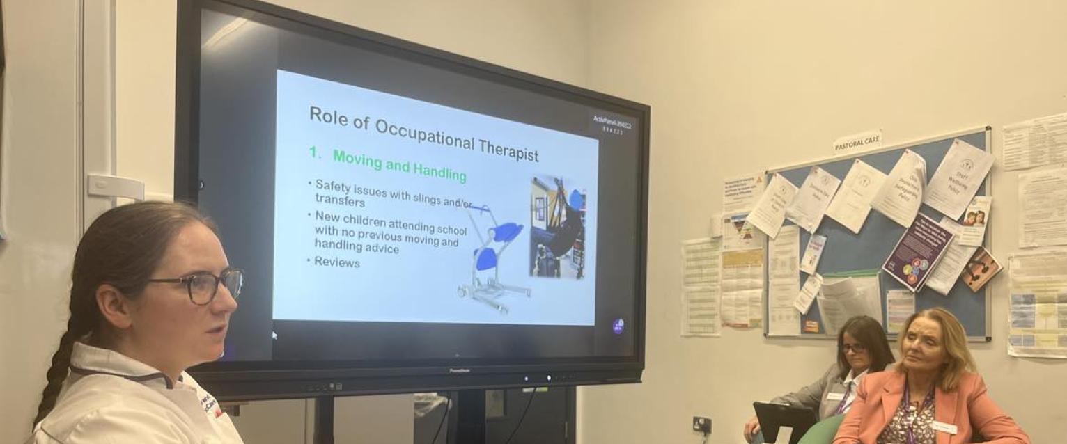 Students sitting in front of a screen that reads "Occupational Therapy"
