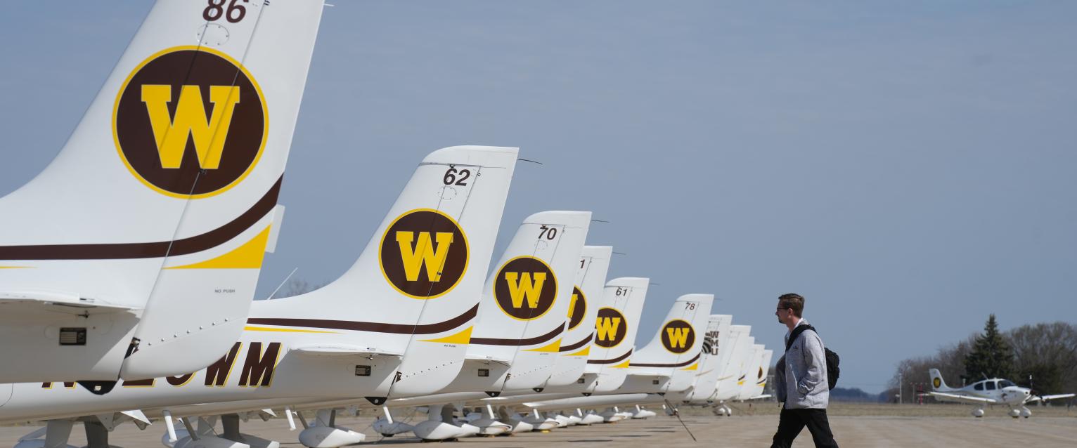 Person walking by planes