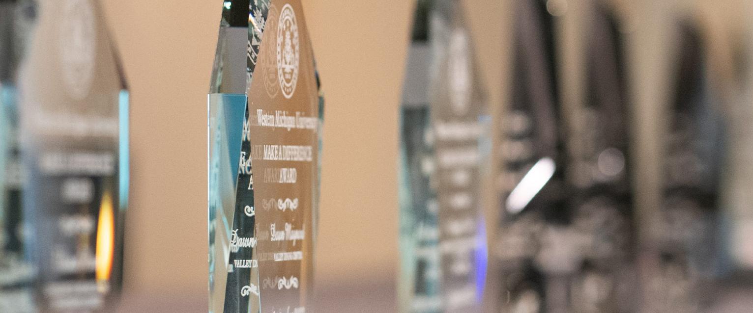 A focused line up of awards on a table at a WMU award ceremony