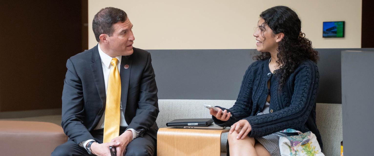 President Kavalhuna talking with a student in the WMU Student Center.