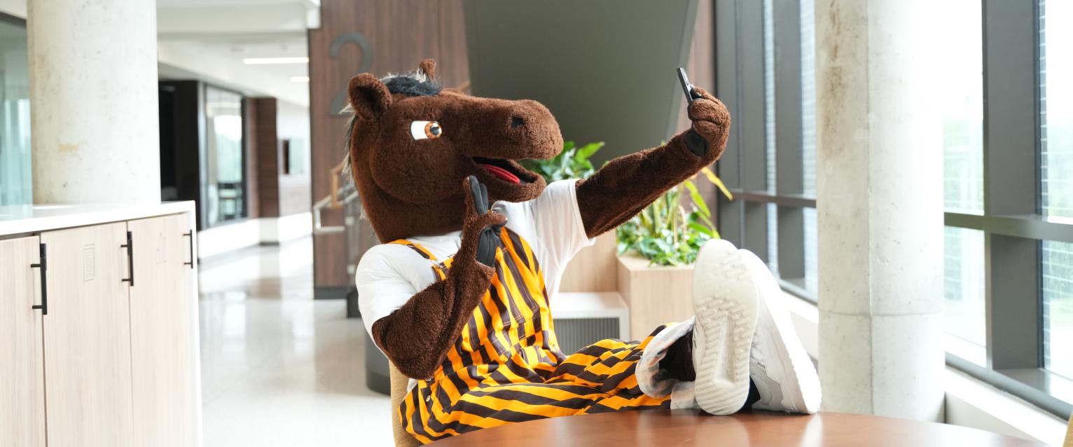 Buster taking a selfie on his phone.