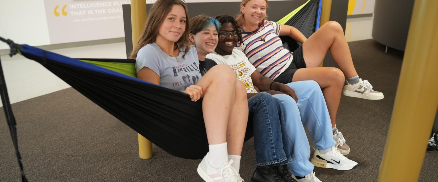 Students sit in a hammock at the Student Center