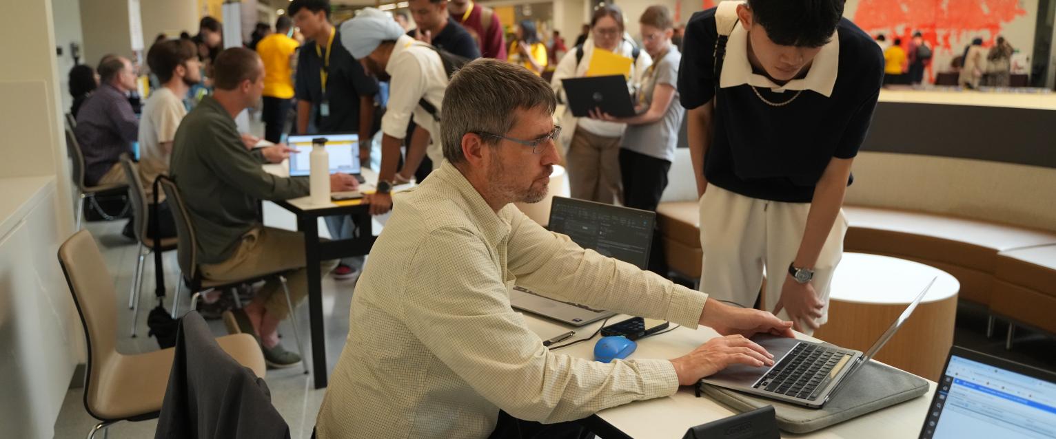An international admissions counselor helping students at International Student Orientation. 
