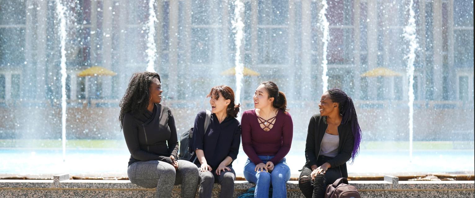 Four young feminine friends at the Miller Plaza foundation