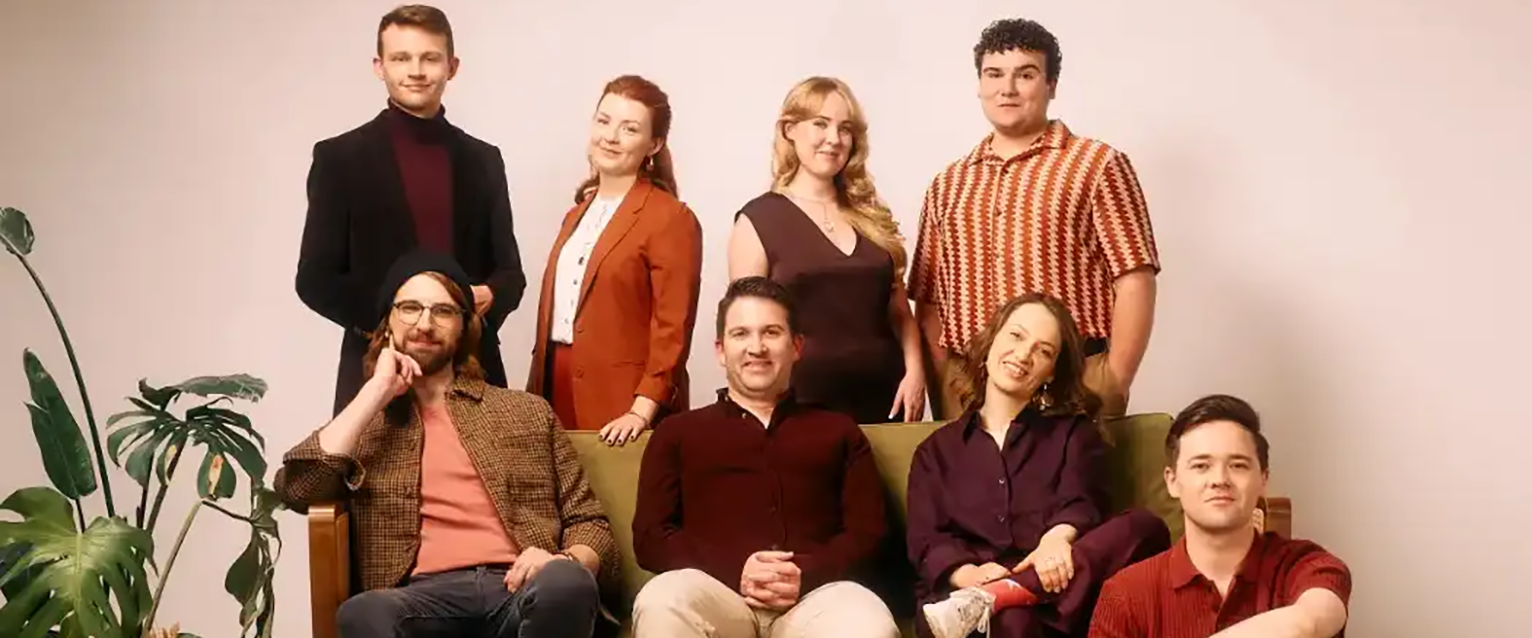 photo of 8-person singing group sitting and standing