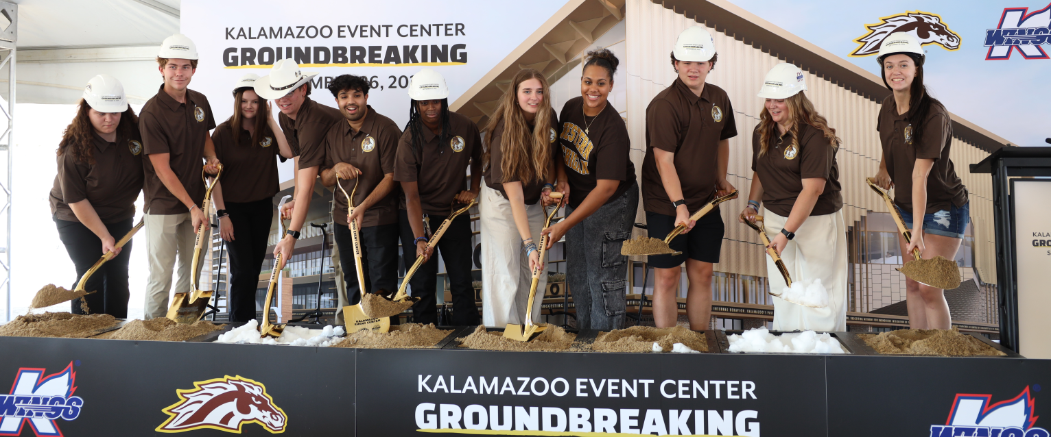 Members of the Lawson Lunatics toss ceremonial shovels of dirt.