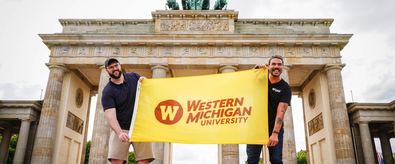 WMU students are seen holding the WMU flag in Berlin.