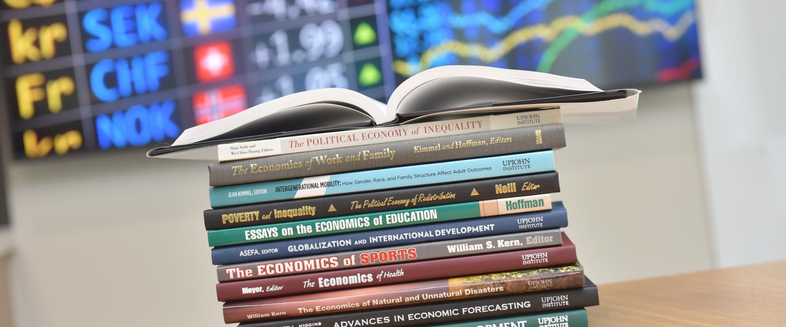 Stack of Economics Textbooks 