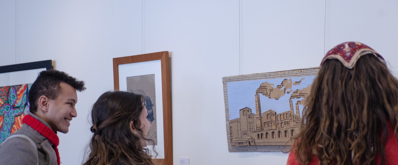 Three students looking at art at the Office for Sustainability