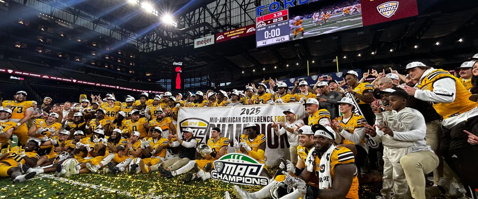 Bronco football players pose at Ford Field after winning MAC championship