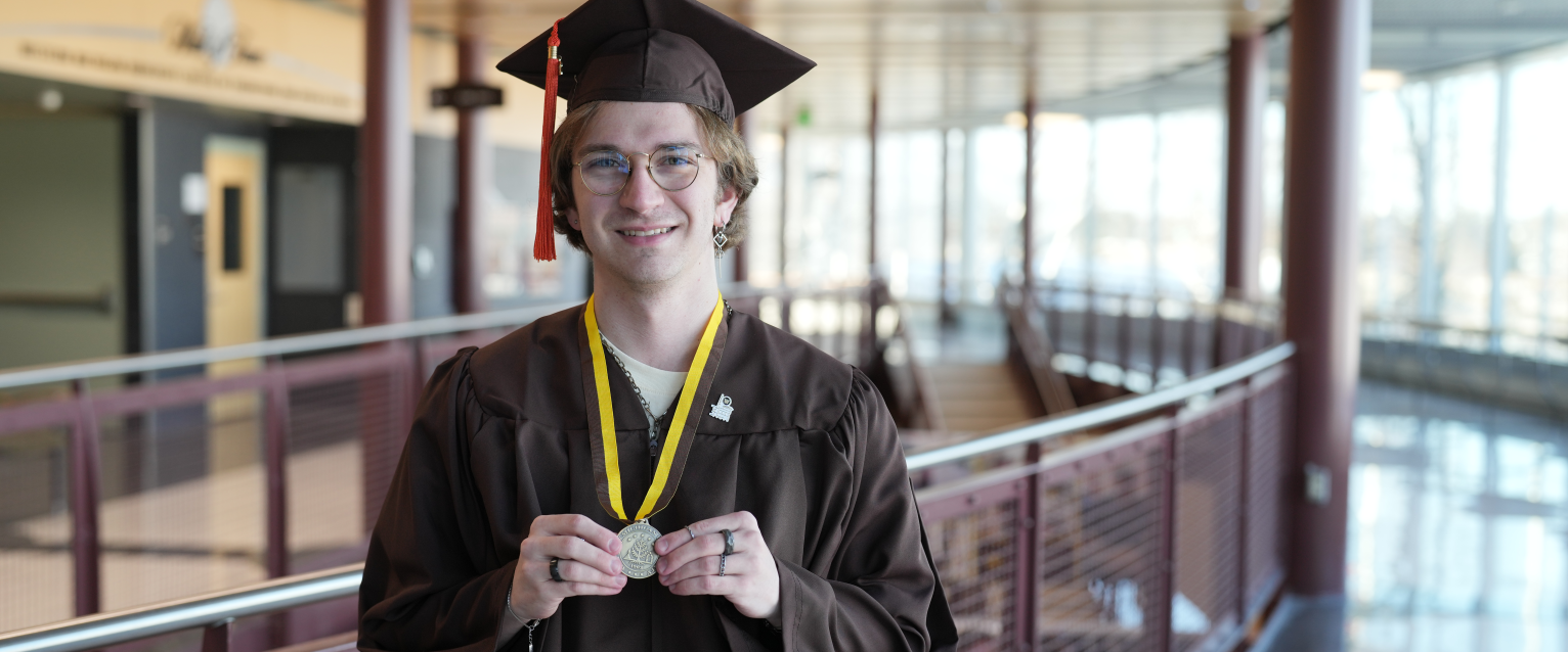 A portrait of Noah Braasch in his graduation regalia.