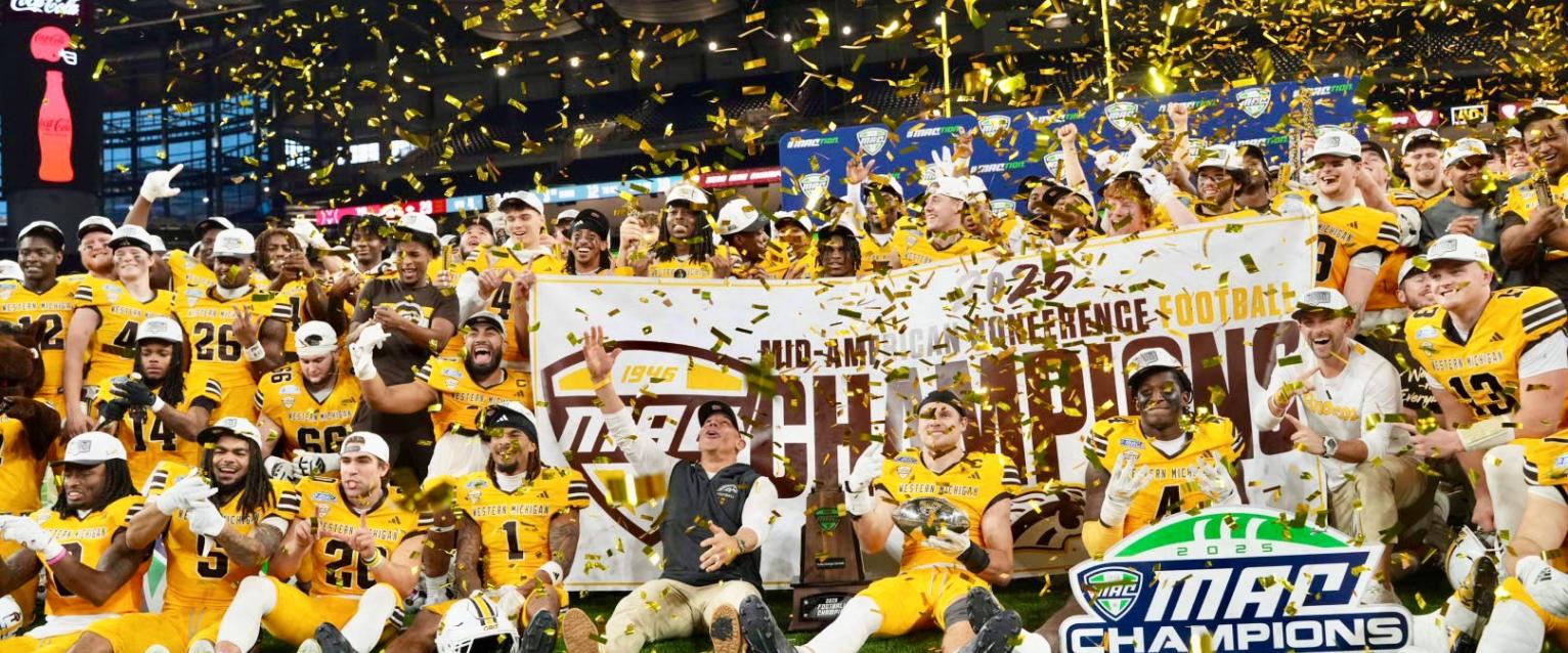 With confetti flying, WMU football players pose after win at Ford Field for MAC Championship