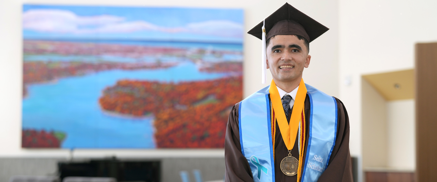 A portrait of Mehran Najafi wearing his graduation regalia.