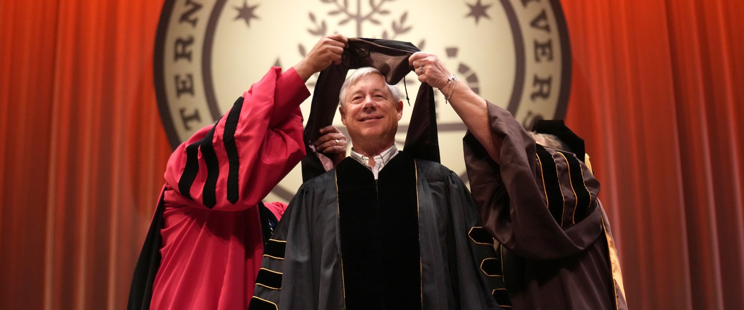 Former U.S. Congressman Fred Upton receives his honorary degree from Western Michigan University on the stage at Miller Auditorium.