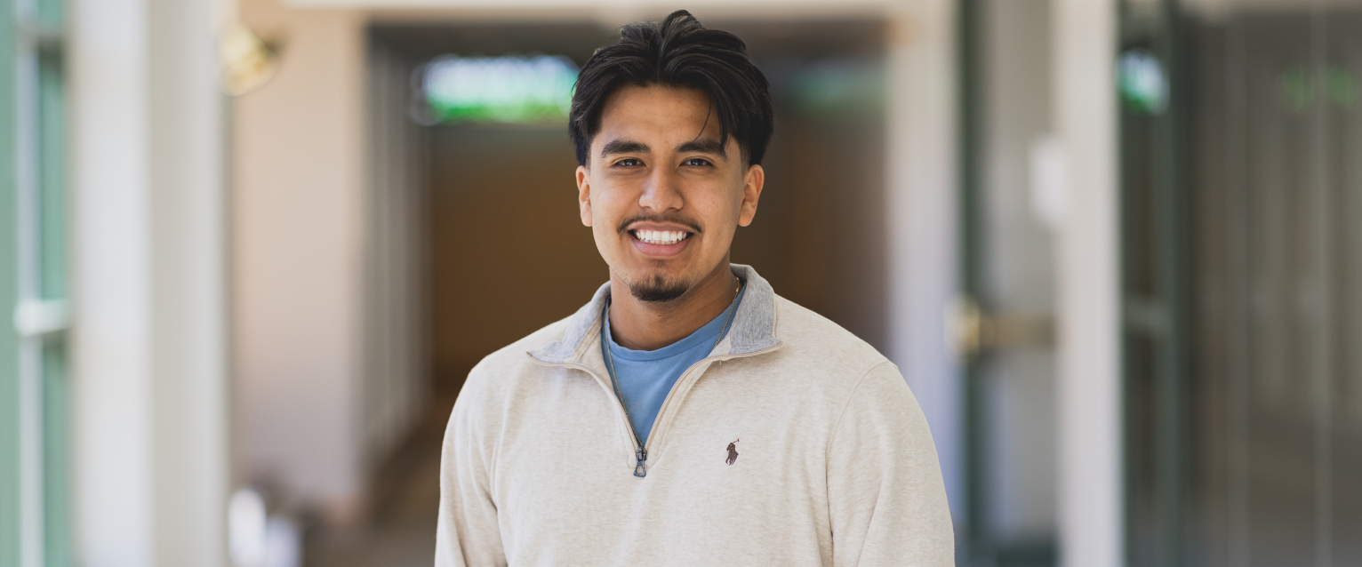 Adrian Flores standing in Schneider Hall
