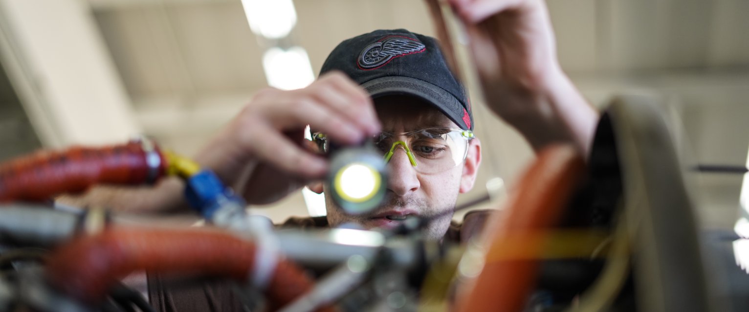 Person looking inside of engine