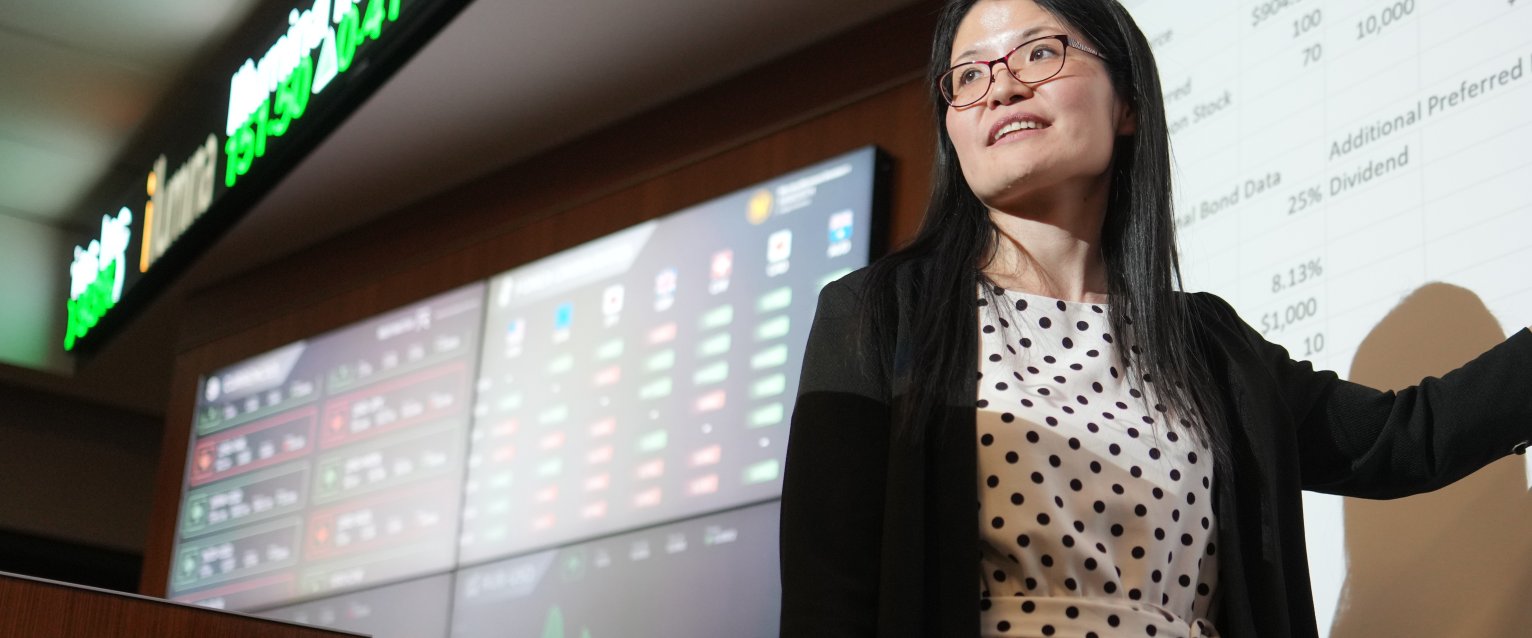 HCOB faculty in front of presentation