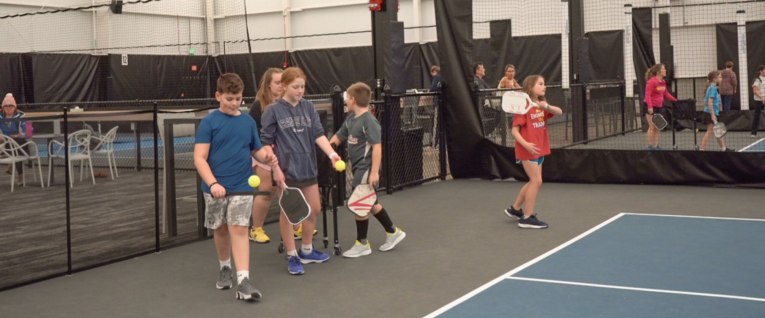 A group of youth at the serving line