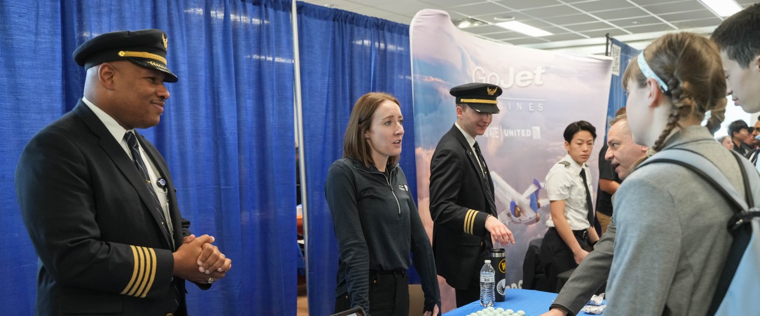 Students at Aviation Outlook Day talking to an exhibitor booth