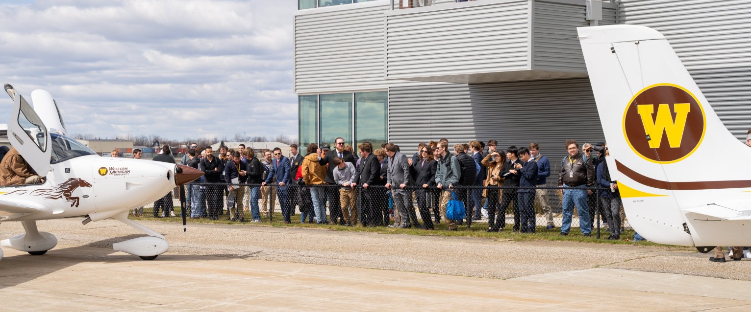 Group of students watching planes at Aviation Education Center.