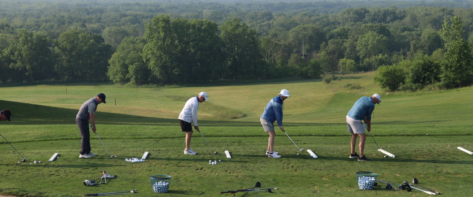 group of golfers at range