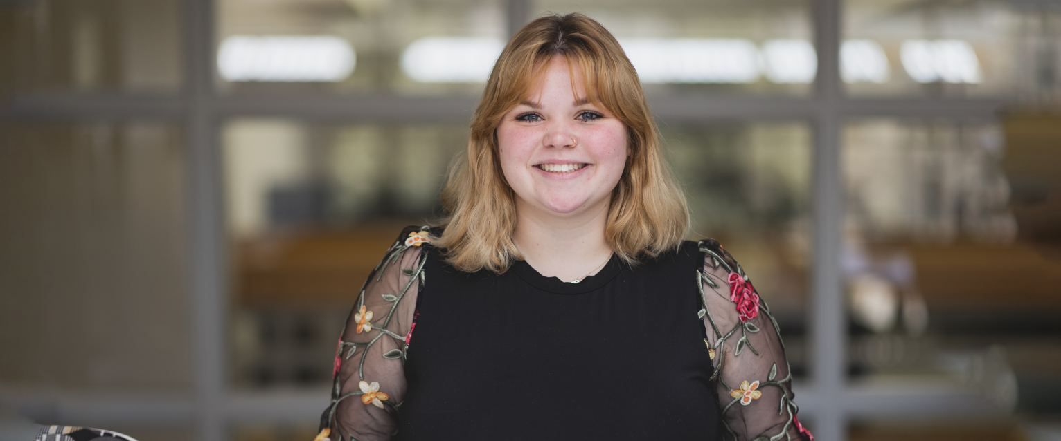 Lyndsey Sootsman wearing a black shirt standing in a conference room