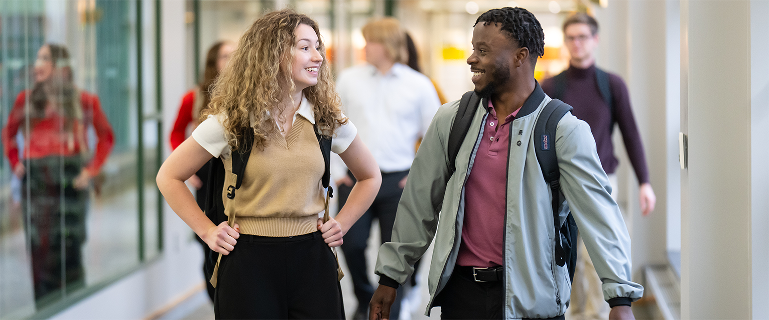 Two WMU Haworth students walking through Schneider Hall.